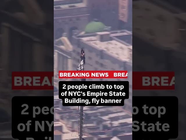 2 people climb to top of NYC's Empire State Building, fly banner