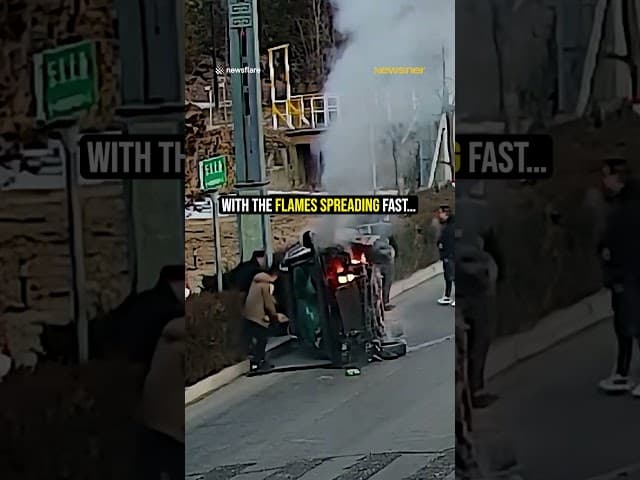 Strangers save trapped driver from burning car